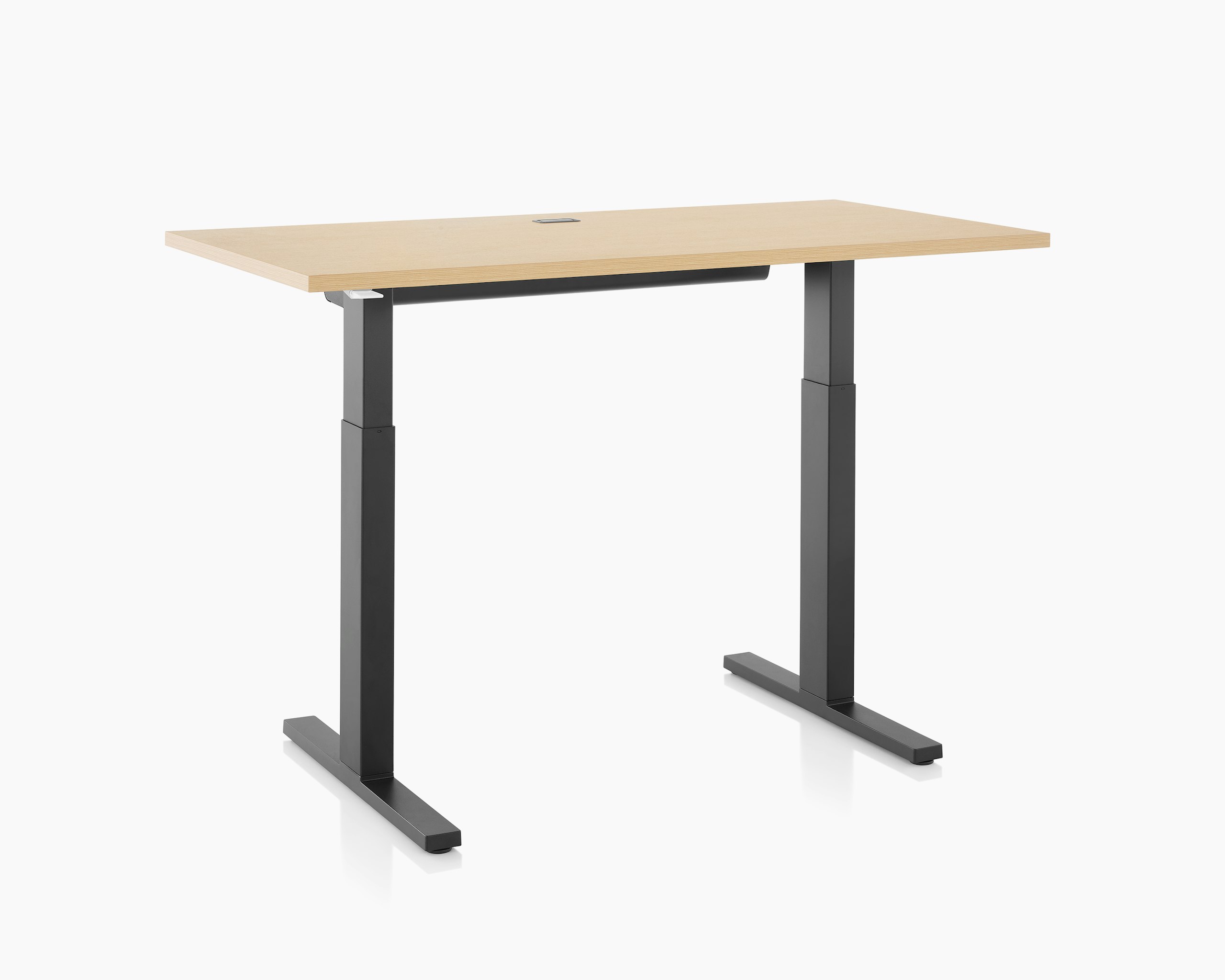 Brown and black Motia sit-to-stand table with cable trough, viewed at an angle.